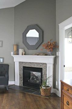 a living room with a fire place and a mirror on the wall above it's mantle