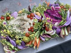 an arrangement of vegetables and herbs on a table