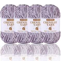 four skeins of yarn are shown in three different colors, one is light gray and