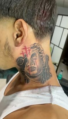 a man with a cross tattoo on his neck and behind his head is a woman's face