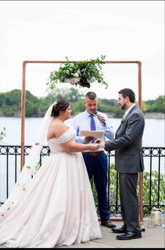 a bride and groom exchanging vows at their wedding ceremony