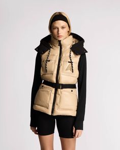 The lightweight Vercors Puffer vest combines fashion-forward design with functionality, making it a statement piece from fall to winter. Made from 90% recycled materials, lined with Eco-Gloss recycled nylon, and filled with ECO-PUFF® thermal insulation technology, the vest is designed for adaptability. Features include a magnetic belt, a removable hood, and a durable paracord at the hood for adjustability Exposed Front Zip Closure High Stand Collar Removable Snap-Off Hood with Adjustable Paracor Utility Vest, Thermal Insulation, Puffer Vest, Lining Fabric, Paracord, Stand Collar, Insulation, Fashion Forward, Top Brands