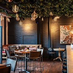 an empty restaurant with lots of tables and chairs