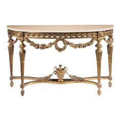 an ornately decorated console table with marble top