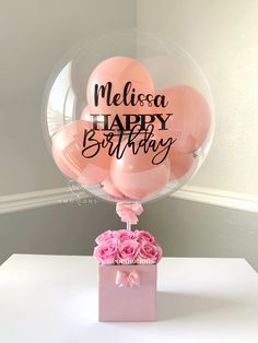 a bunch of balloons that are in a vase with the words happy birthday on it