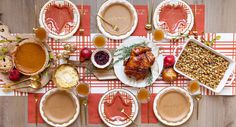 a table topped with lots of food on top of a red and white checkered table cloth