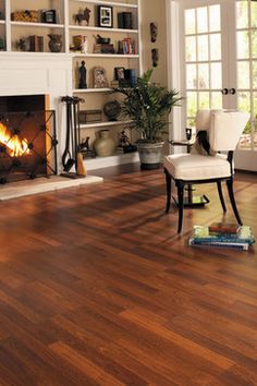 a living room filled with furniture and a fire place in the middle of the room