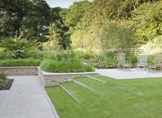 an outdoor garden with grass and stone steps