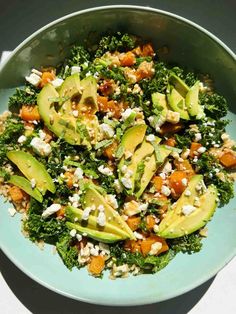 a bowl filled with broccoli, avocado and feta cheese