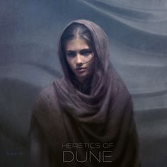 a woman wearing a brown shawl with the words heretic of dune on it