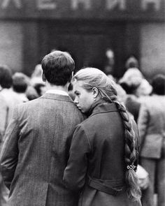 two people standing in front of a building