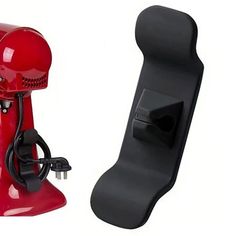 a red and black object is next to a skateboard on a white background,