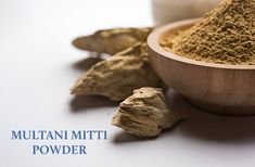 a wooden bowl filled with mutilan mitt powder next to some cut up leaves