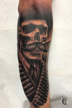 a man with a mustache and skull tattoo on his leg