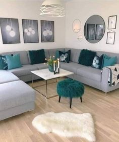 a living room filled with lots of furniture and pillows on top of it's wooden floors