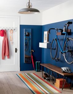 an image of a room with blue walls and bikes on the rack in front of it