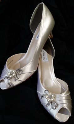 two pairs of wedding shoes with pearls on them