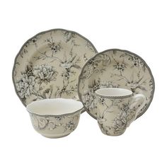 an image of a set of dinnerware with flowers on the plate and cups in front