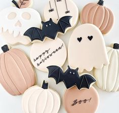 decorated halloween cookies with bats, pumpkins and skulls on them are arranged in a circle