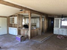 an empty room with unfinished walls and cabinets