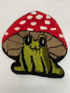 a patch with a mushroom on it that is green and has white hearts in the background