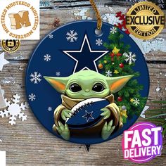 a christmas ornament with an image of baby yoda holding a football ball