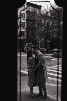 a man and woman kissing on the street