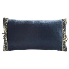 a blue pillow with gold trimmings on it