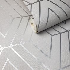 a close up view of a wallpaper with lines and shapes on the surface,