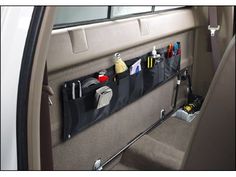 the back seat of a car with various items hanging from it's hooks and pockets