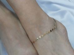 Elevate your ankle game with our gorgeous gold disc ankle bracelet. It features sparkly gold fill sequin discs in a classic style. The anklet closes with a clasp and includes an extender chain for adjustment. Perfect minimalist wear, summer anklet and as gifts for beach wedding bridesmaids. Made to a length of 10 inches plus 1 inch extender chain. The anklet comes boxed ready for gifting. Please contact me if you have any questions. Thanks for looking. To view other bracelets, please click here http://www.etsy.com/uk/shop/GemmaJolee?section_id=13763887 To view other items in the shop click here http://www.etsy.com/uk/shop/GemmaJolee?ref=si_shop Delicate Gold Bracelets For Summer, Gold Bracelet With Delicate Chain For Summer, Gold Delicate Chain Bracelet For Summer, Gold Minimalist Anklet For Wedding, Delicate Gold Chain Bracelet For Summer, Gold Delicate Anklets For Summer, Delicate Gold Anklets For Summer, Minimalist Gold Anklet For Wedding, Dainty Gold Anklets For Wedding