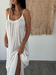 Step into summer elegance with our Organic Linen Maxi Dress, designed to embody both comfort and style. This exquisite dress combines organic linen and cotton, creating a breathable and soft fabric that drapes beautifully. Featuring a flowing silhouette, it captures the essence of boho chic, making it perfect for beach outings, garden weddings, or as a stylish guest dress. The natural fibers enhance its earthy appeal, aligning with a sustainable fashion ethos. Ideal for the fashion-conscious wom Breezy Long Dress For Beach Cover-up, Flowy Summer Dresses For Beach Wedding, Beach Dress With Spaghetti Straps, Flowy Beachwear Sundress For Daywear, Beach Wedding Sundress In Maxi Length, Summer Maxi Beach Dress For Daywear, Breezy Beach Midi Dress With Spaghetti Straps, White Bohemian Maxi Dress With Spaghetti Straps, Flowy Midi Dress With Spaghetti Straps For Beach