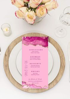 a place setting with pink and white flowers