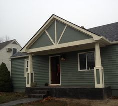 a house with green siding and white trim