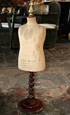 a wooden mannequin on display in a store