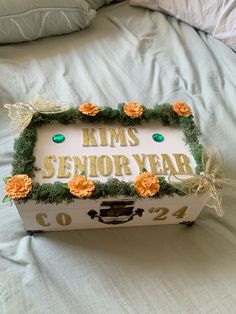 a decorative box that says kims senior year with flowers and leaves on the inside