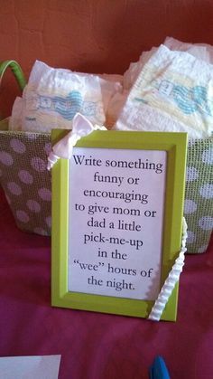 a green frame with a poem on it sitting next to some diapers and scissors