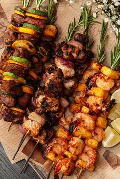 several skewers of meat and vegetables on a table