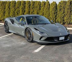 a grey sports car parked in a parking lot