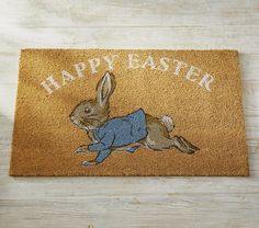 a door mat with an image of a rabbit on it and the words happy easter