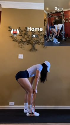 a woman in shorts and white shirt doing squats with crutches on the floor