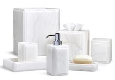 white bathroom accessories including soap dispenser, soap dish and tissue dispenser