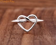 Solid 925 Sterling Silver Dainty Minimalist Heart Pretzel Overhand Knot Promise Ring Wedding Anniversary Jewelry ▷Gift Box Included ▷10mm Height ▷Size 3 - 10 Available ▷925 Sterling Silver (not plated or filled) ▷925 Stamp Authenticity https://www.etsy.com/shop/TrendyRing Adjustable Heart Ring For Valentine's Wedding, Adjustable Heart Ring For Wedding On Valentine's Day, Silver Heart Ring For Wedding On Mother's Day, Adjustable White Gold Heart Ring For Wedding, Dainty Silver Heart Ring For Mother's Day, Adjustable Open Heart Wedding Rings, Dainty Silver Heart Ring For Wedding, Silver Heart Ring For Wedding On Valentine's Day, Silver Heart Ring For Wedding With Open Heart Design