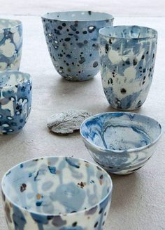 blue and white bowls sitting on top of a table