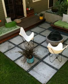 a patio with two chairs and a fire pit