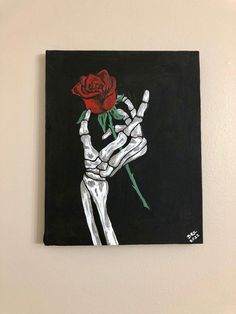 a painting of a skeleton holding a rose