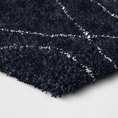 a black and white area rug with fringes