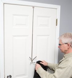 an older man is opening the door to his apartment