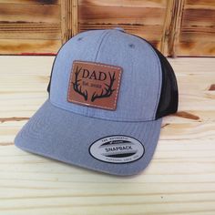 Celebrate the dads in your life with this custom laser engraved dad with deer antlers and established date leather patch hat. The hats are the popular trucker style snap-back that look great and are available in several colors - see available colors. Shipped in a full size box so you will receive your hat in perfect condition.  Looking for something different? We can make any custom patch for you, just message us! Item Care: Spot clean only. Do not machine wash or dry. As this item is a custom made item, refunds and returns are not offered. If there is a problem with the order please contact us and we will help to resolve. Hat Details: Material: 65% polyester and 35% cotton Size: Adult with snapback adjustable. Patch Details: Vegan friendly leatherette patch Great for: Gift for dad Gift fo Father's Day Snapback Hat With Leather Patch, Father's Day Snapback Trucker Hat With Leather Patch, Brown Trucker Hat For Father's Day Outdoor, Father's Day Brown Hat With Leather Patch, Brown Outdoor Hats For Father's Day, Brown Outdoor Hat For Father's Day, Brown Hats For Father's Day Outdoor, Father's Day Outdoor Brown Hat, Outdoor Hats With Leather Patch For Father's Day