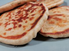 three pancakes sitting on top of a blue plate